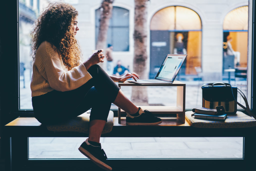 woman working in a coffeeshop window