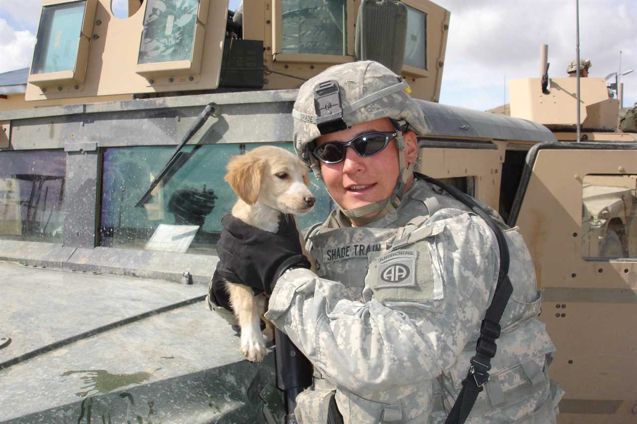 Dave Shade in his army uniform with a puppy.