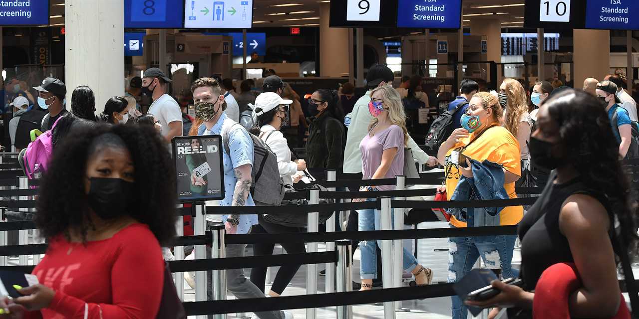 Airline passengers wait in line at an airport security checkpoint