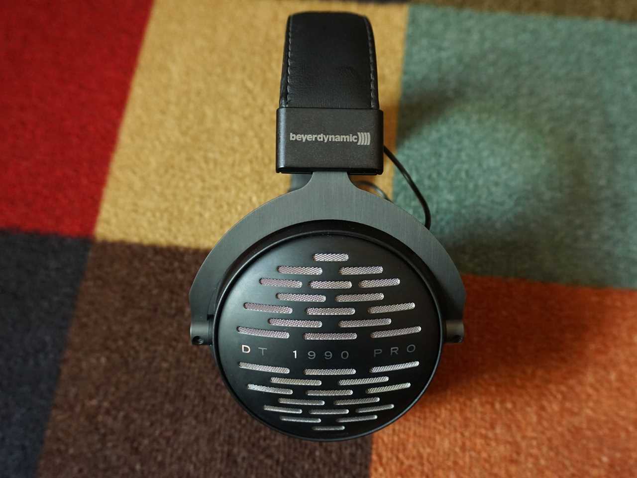 The side of the Beyerdynamic DT 1990 Pro on a patterned carpet - best high-end over-ear headphones