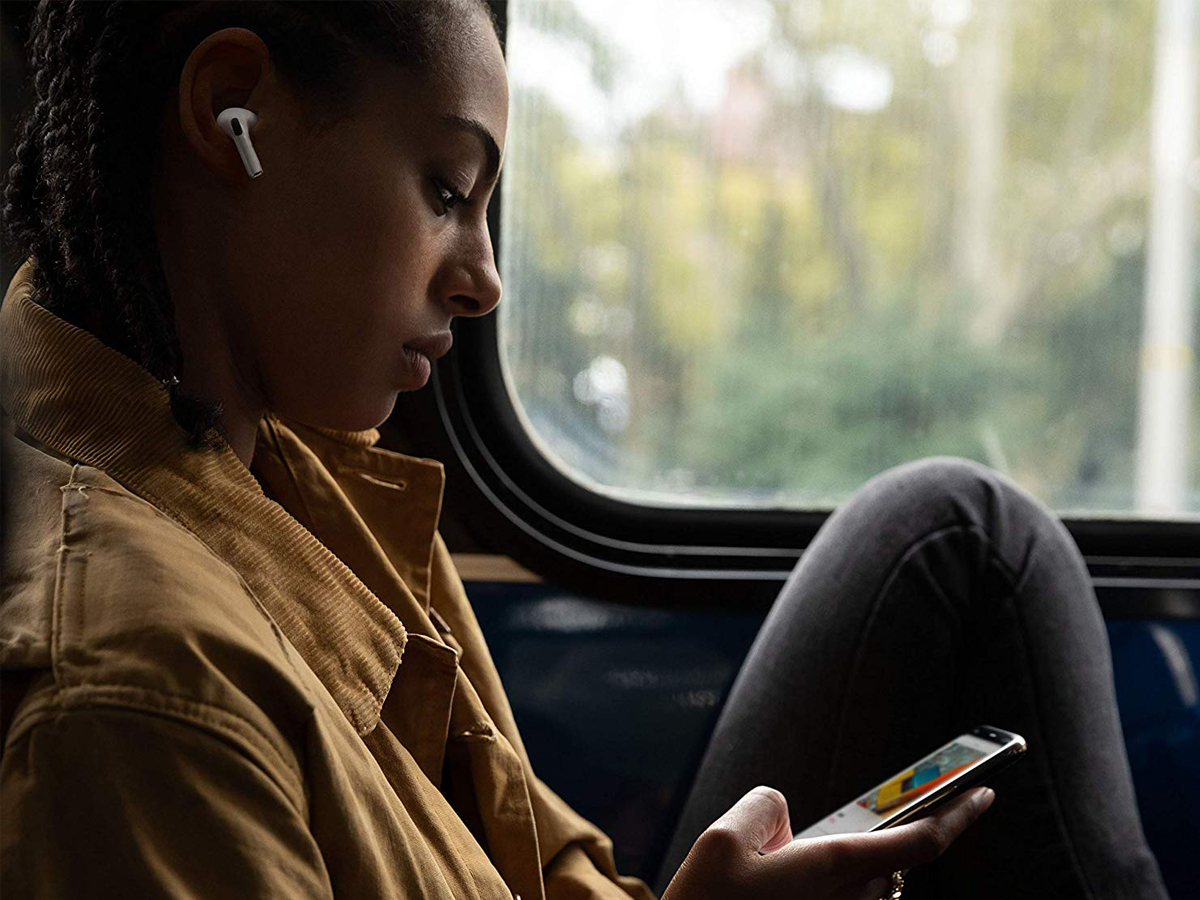 Woman wearing Apple AirPods Pro while commuting