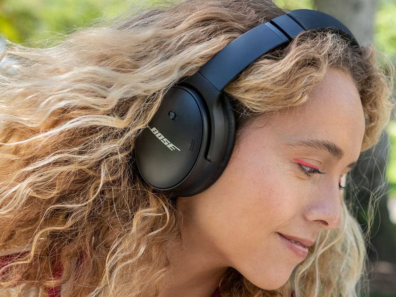 The Bose QuietComfort 45 wireless noise cancelling headphones being worn on a person’s head.