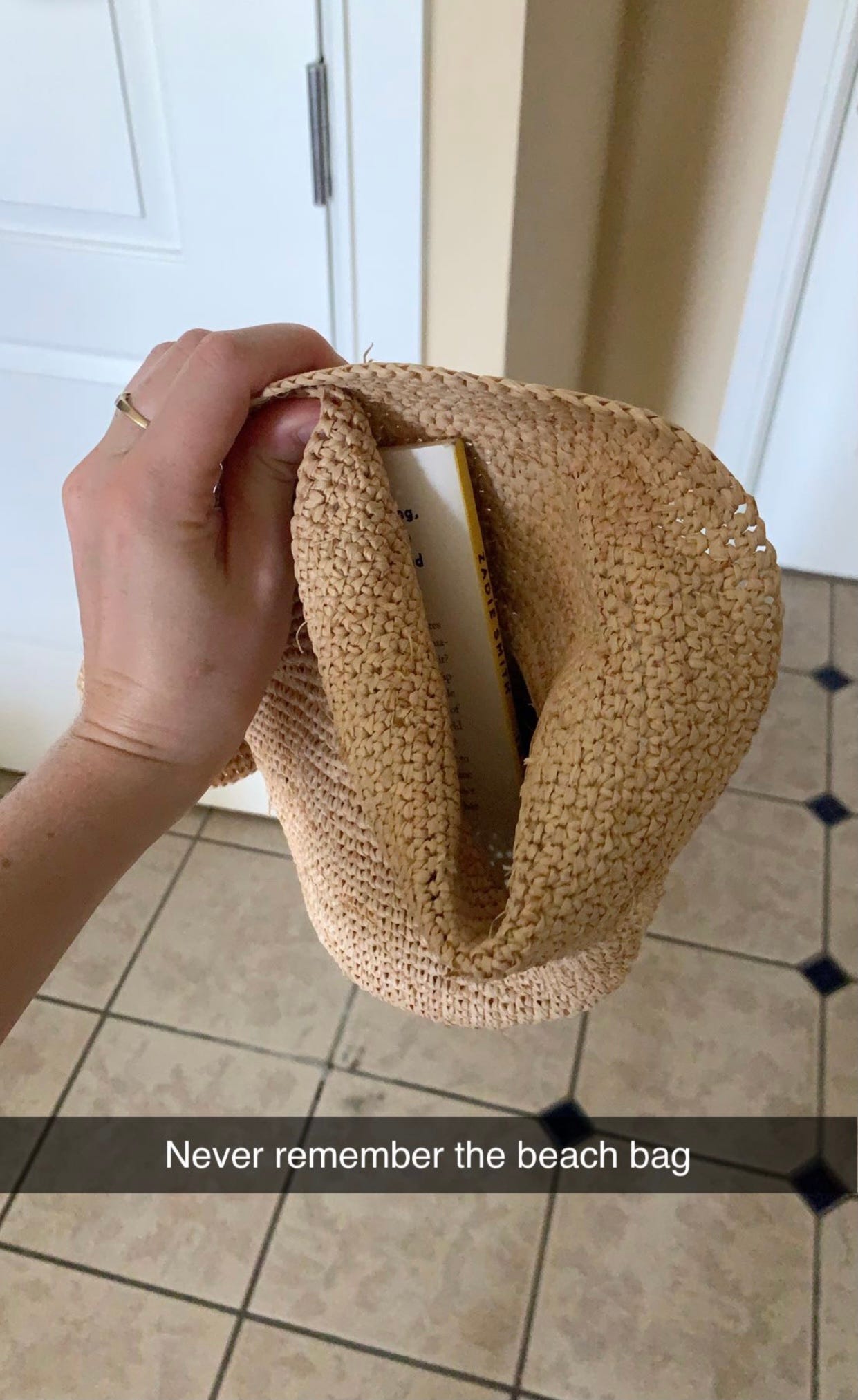 Zadie Smith's book "Intimations" in a beach hat.