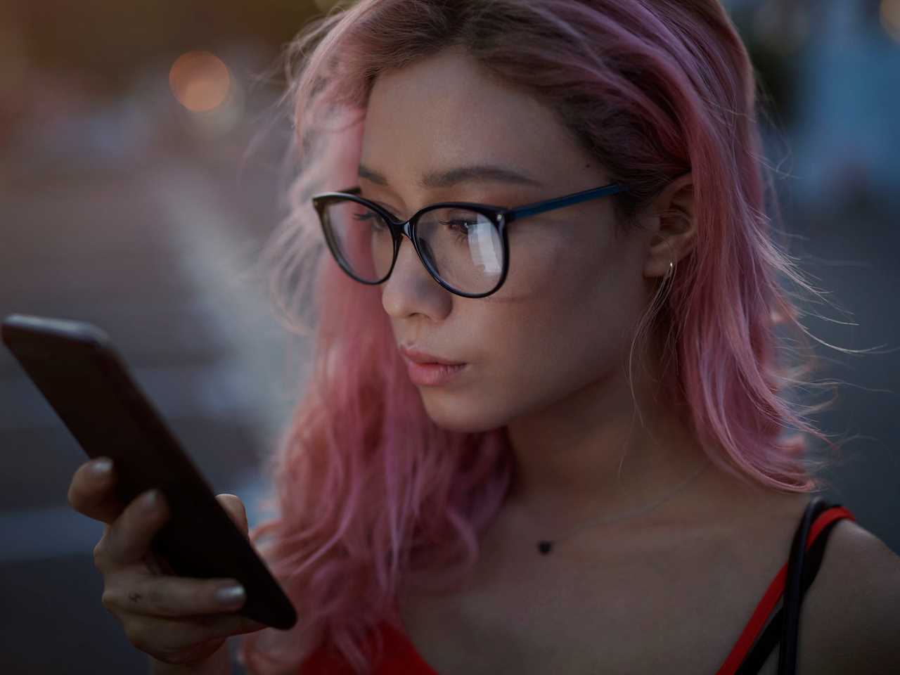 looking at phone texting outside night