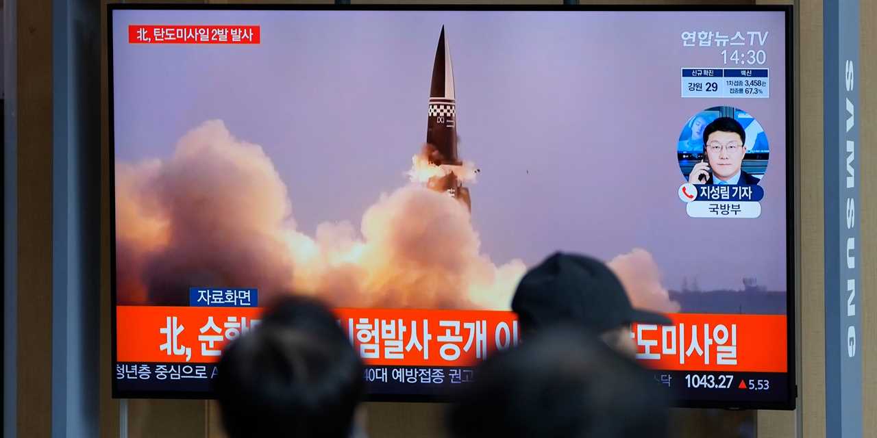 People watch a TV screen showing a news program reporting about North Korea's missiles with file image, in Seoul, South Korea, Wednesday, Sept. 15, 2021