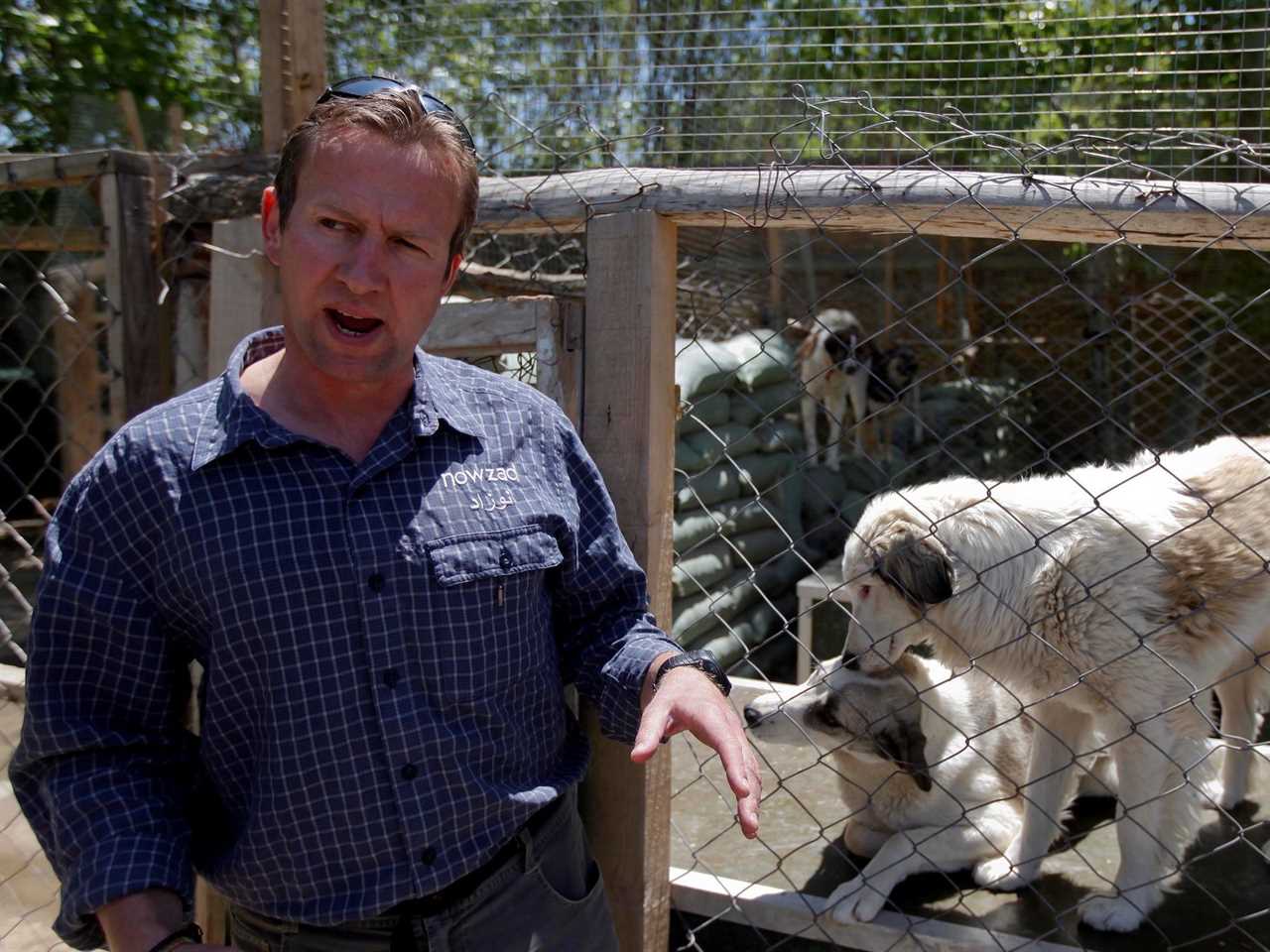 Pen Farthing, founder of British charity Nowzad, an animal shelter, stands in front of a cage on the outskirts of Kabul.